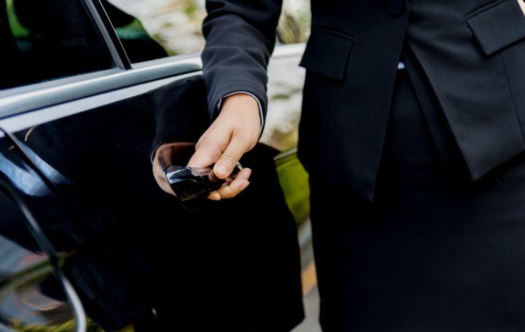 A chauffeur opening a door