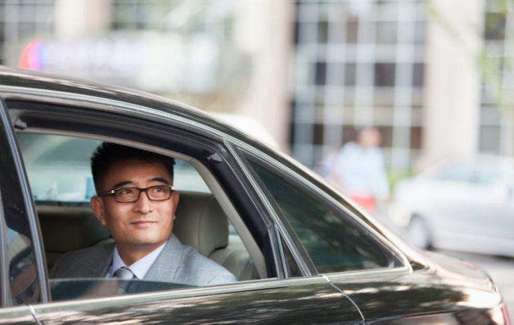 A man looking out the window in the car