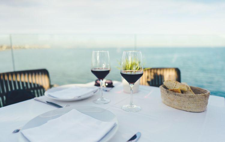 A table set up near the water at a nice restaurant