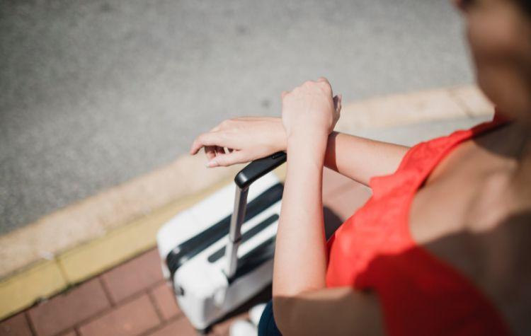 A woman waiting with luggage