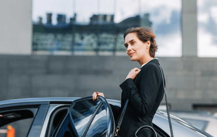 A business women getting in the black car with confidence