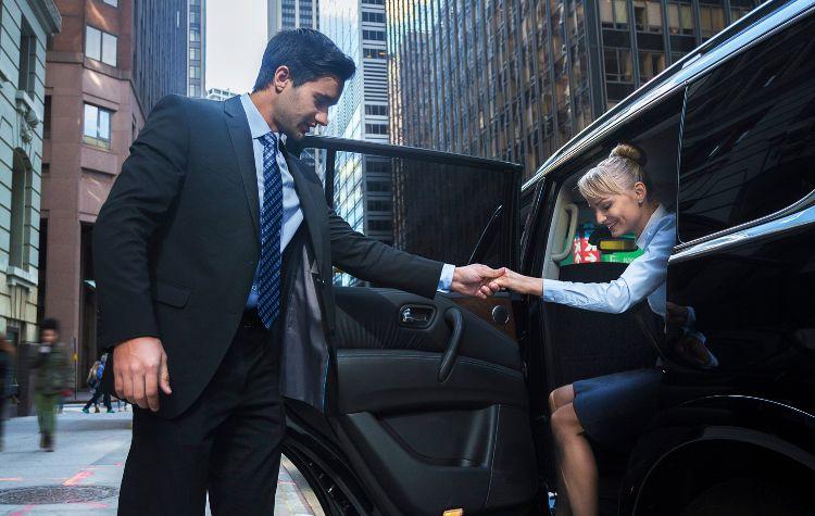 Chauffeur letting passenger out of a car