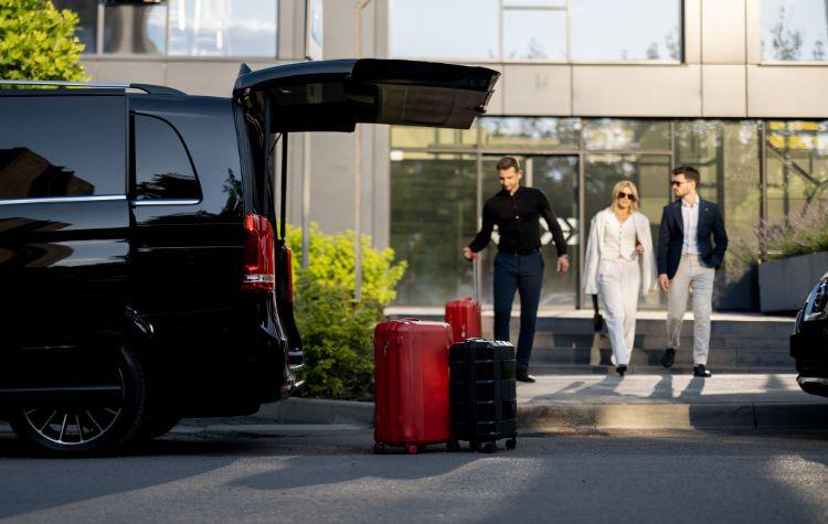 Chauffeur picking up passengers for their airport ride