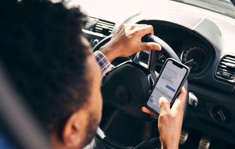 Man texting in a car