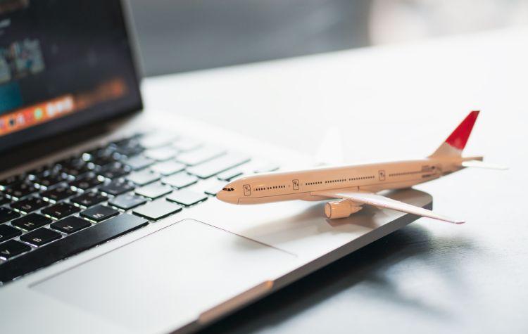 Model airplane sitting on a laptop