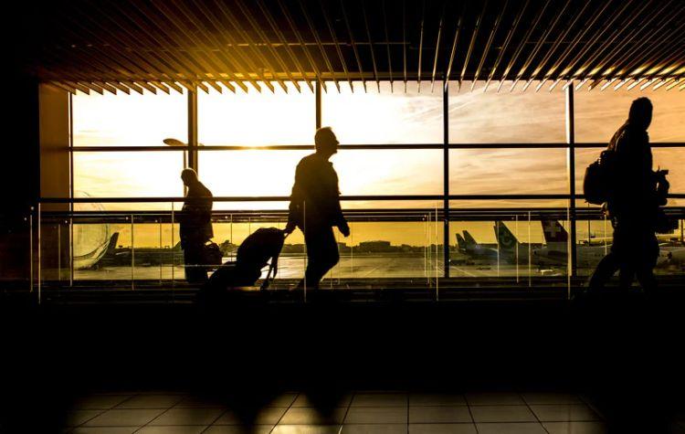 People passing through a darkened airport