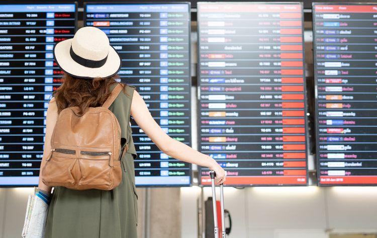 Person looking at the board of flight updates in the airport