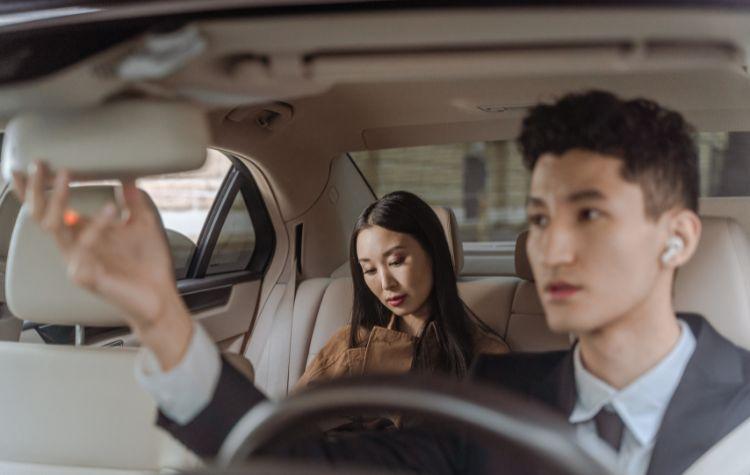 Safe chauffeur driving a business passenger