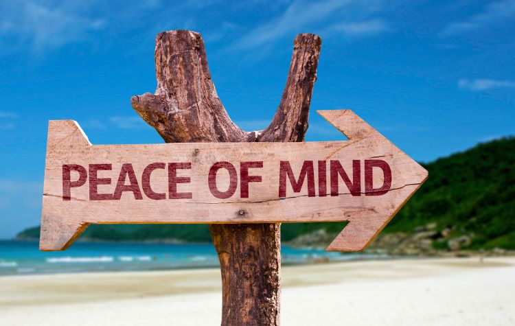 Sign on a Beach that reads 'Peace of Mind'