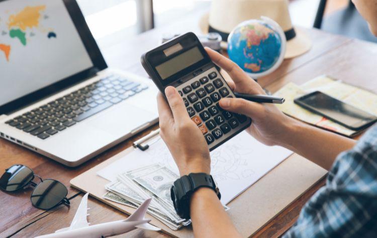 Someone budgeting their travel at a desk