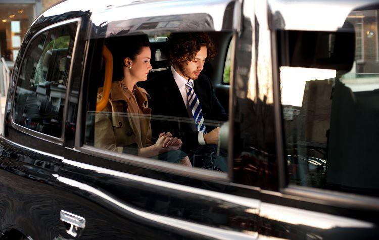 Travelers in the back of a corporate car