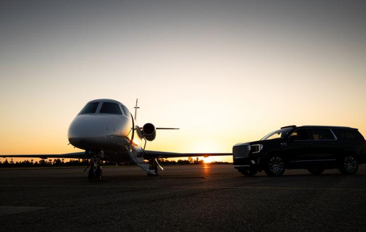 A black car service on the airport terminal next to the aircraft