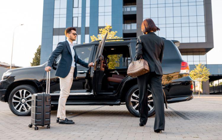 Woman getting into black car ride headed to the airport