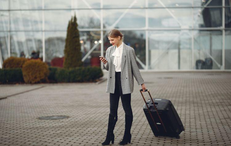 Woman outside the airport walking to her airport transfer