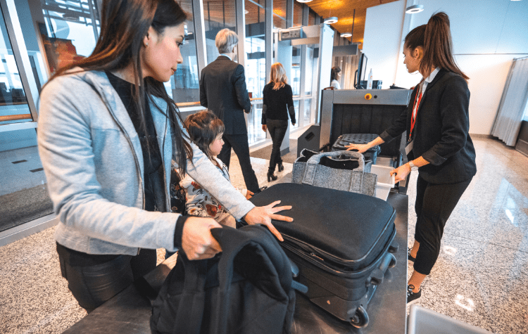 Women about to go through TSA with a child