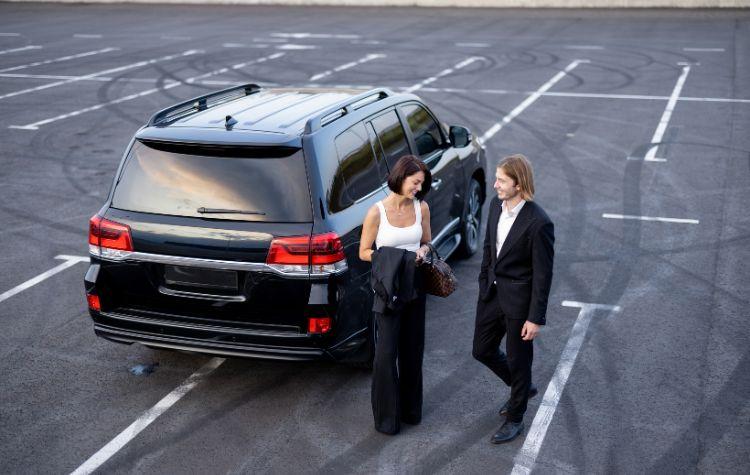 Woman and man standing outside a private ride